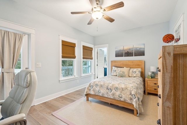 bedroom featuring multiple windows, ceiling fan, and light wood-type flooring