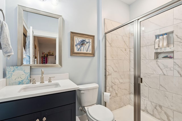 bathroom with toilet, vanity, and walk in shower