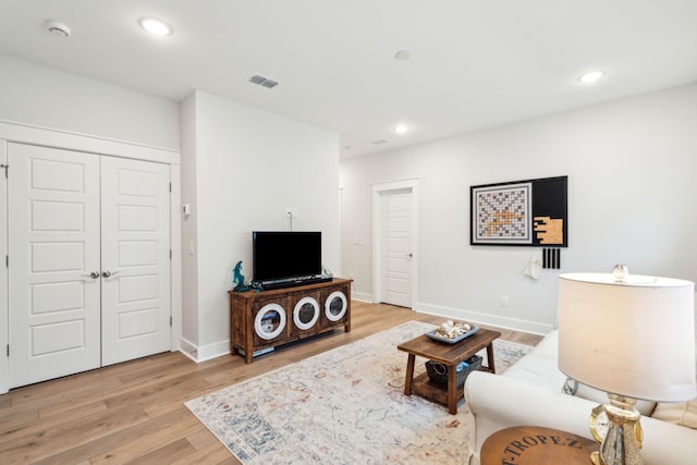 living room with light hardwood / wood-style flooring