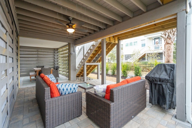 view of patio with an outdoor living space and ceiling fan