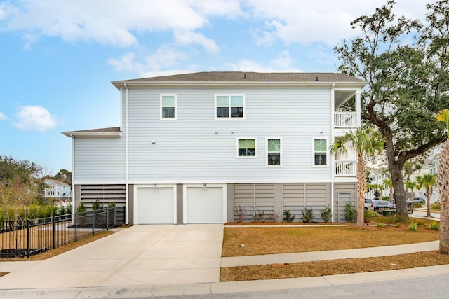 back of property with a garage and a balcony