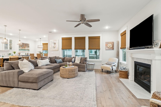 living room featuring ceiling fan and light hardwood / wood-style floors