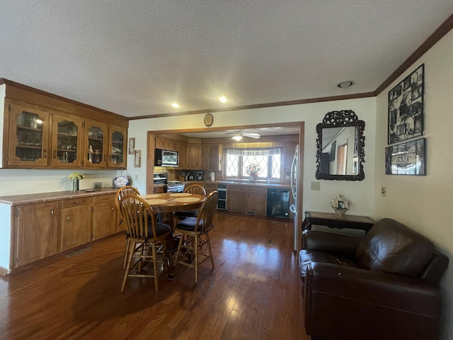 dining area with dark wood-style floors, wine cooler, crown molding, and a textured ceiling