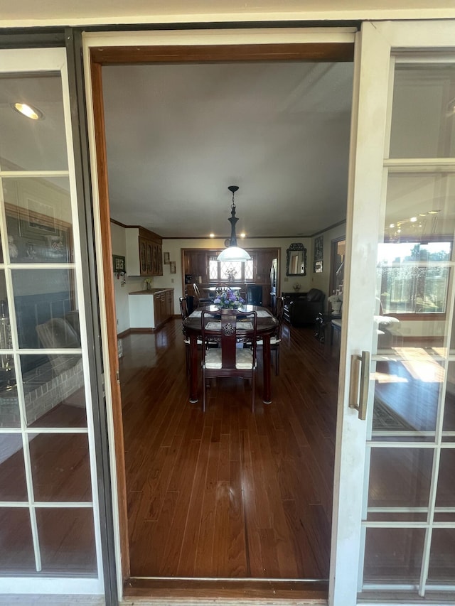 dining space with dark wood-style flooring