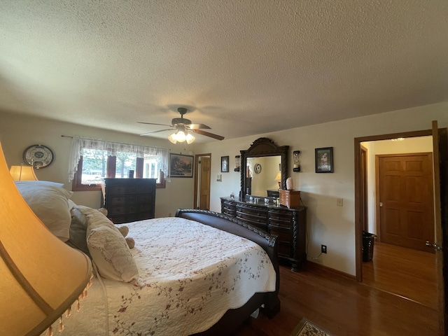 bedroom with ceiling fan, a textured ceiling, wood finished floors, and baseboards