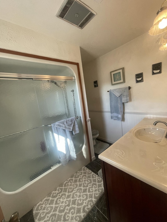 full bathroom with visible vents, toilet, a wainscoted wall, tile patterned floors, and vanity