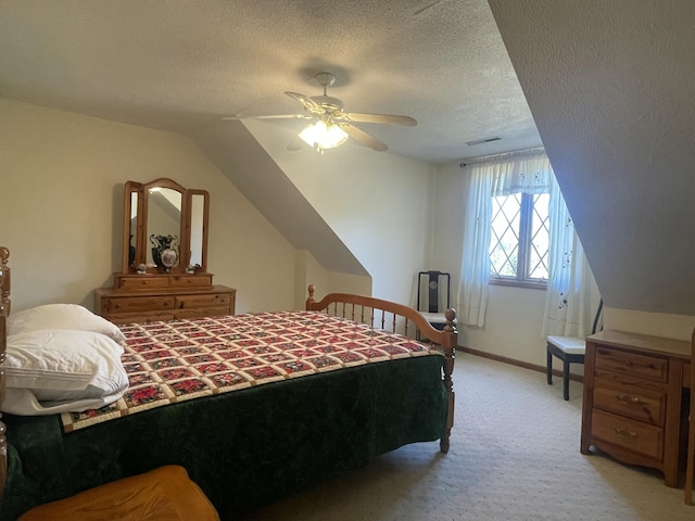 bedroom featuring light colored carpet, visible vents, ceiling fan, a textured ceiling, and baseboards