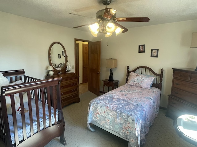 bedroom featuring a ceiling fan and a textured ceiling