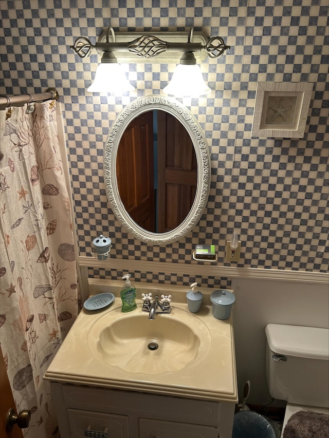 bathroom with toilet, decorative backsplash, and vanity