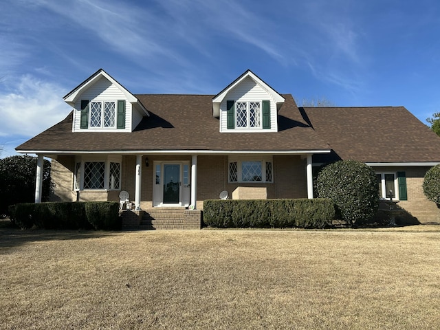 view of front facade featuring brick siding and a front lawn