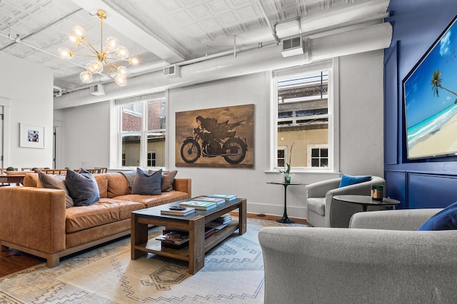 4 Beaufain St Unit 207, Charleston, SC 29401 - living area featuring a chandelier, wood finished floors, and an ornate ceiling