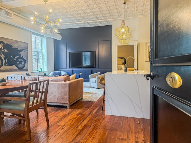 4 Beaufain St Unit 207, Charleston, SC 29401 - living area with an ornate ceiling, a chandelier, and dark wood finished floors