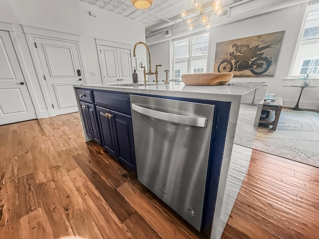 4 Beaufain St Unit 207, Charleston, SC 29401 - kitchen featuring dishwasher, hardwood / wood-style flooring, blue cabinetry, an island with sink, and pendant lighting
