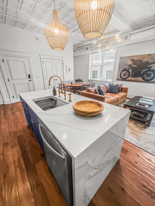 4 Beaufain St Unit 207, Charleston, SC 29401 - kitchen with blue cabinetry, dishwasher, dark wood-type flooring, an island with sink, and hanging light fixtures