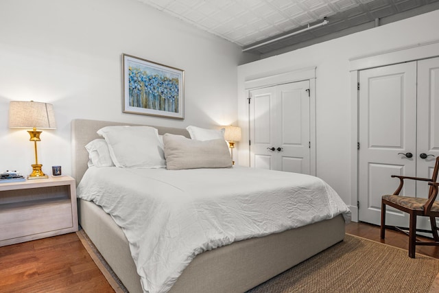4 Beaufain St Unit 207, Charleston, SC 29401 - bedroom featuring wood finished floors, an ornate ceiling, and a closet