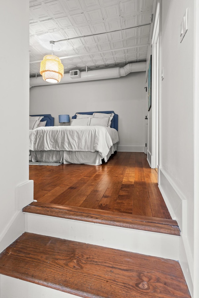 4 Beaufain St Unit 207, Charleston, SC 29401 - bedroom with wood finished floors and baseboards