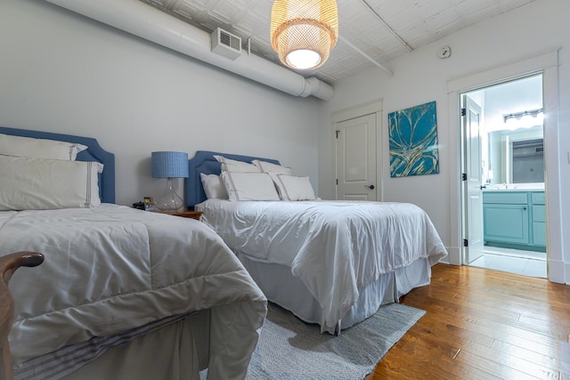 4 Beaufain St Unit 207, Charleston, SC 29401 - bedroom featuring hardwood / wood-style flooring and connected bathroom