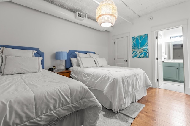4 Beaufain St Unit 207, Charleston, SC 29401 - bedroom with wood finished floors and connected bathroom
