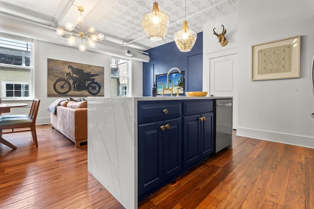 4 Beaufain St Unit 207, Charleston, SC 29401 - kitchen featuring blue cabinets, a chandelier, dark wood-style flooring, open floor plan, and an ornate ceiling