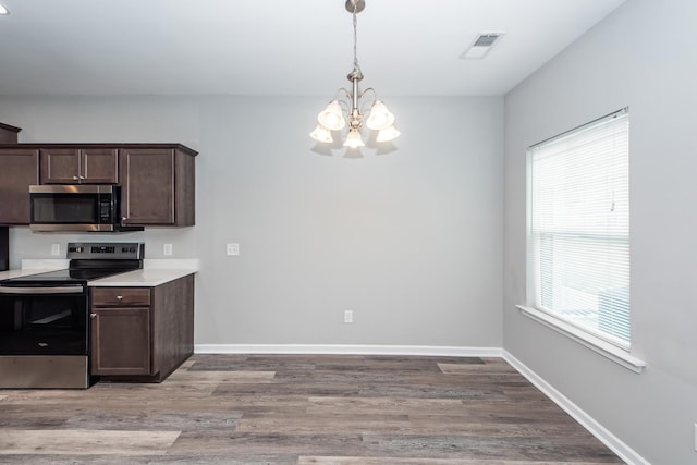 kitchen featuring visible vents, dark brown cabinets, baseboards, a chandelier, and stainless steel appliances