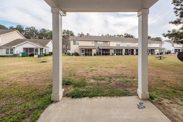 view of yard featuring a residential view and a sunroom