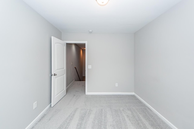 spare room with carpet flooring and baseboards