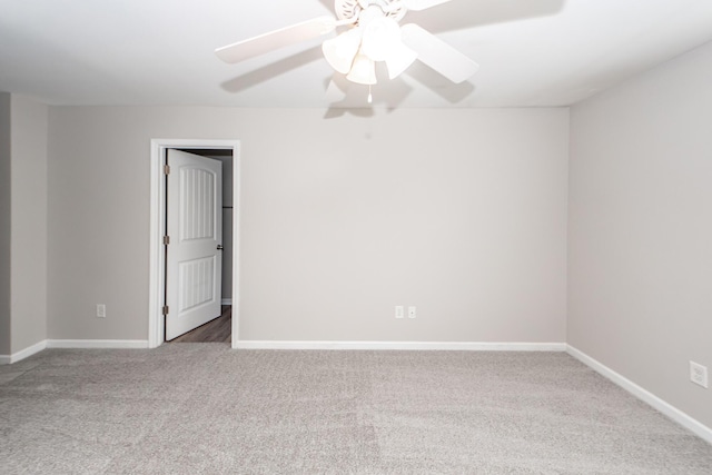 empty room with carpet, baseboards, and ceiling fan