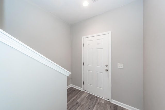 foyer featuring baseboards and wood finished floors