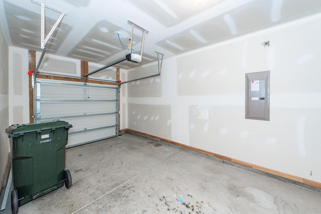 garage with electric panel, a garage door opener, and baseboards