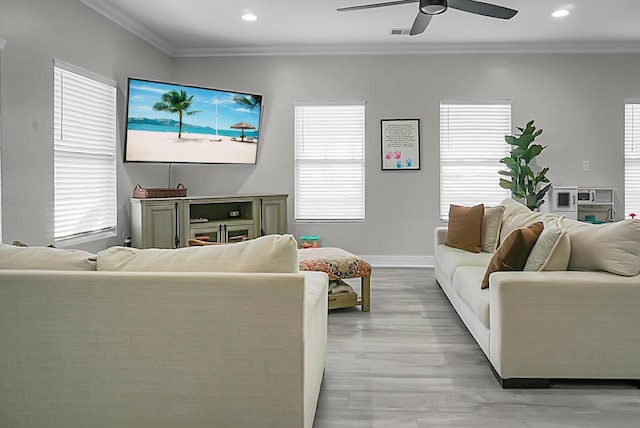 living room with crown molding, ceiling fan, and light hardwood / wood-style floors