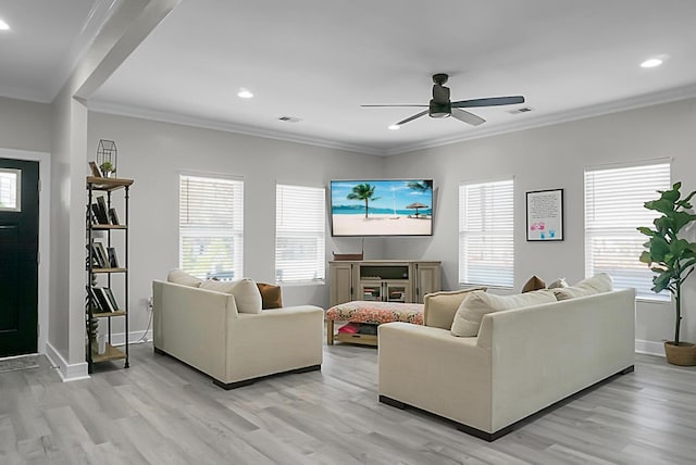 living room with ornamental molding, ceiling fan, and light wood-type flooring