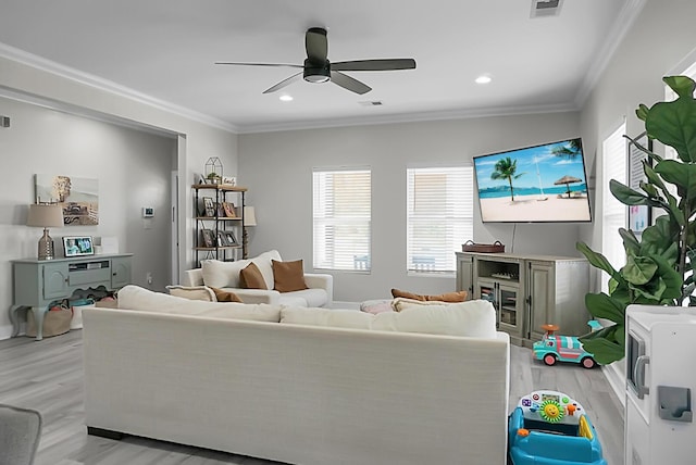 living room with crown molding, ceiling fan, and light hardwood / wood-style flooring