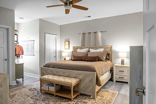 bedroom featuring light hardwood / wood-style floors and ceiling fan