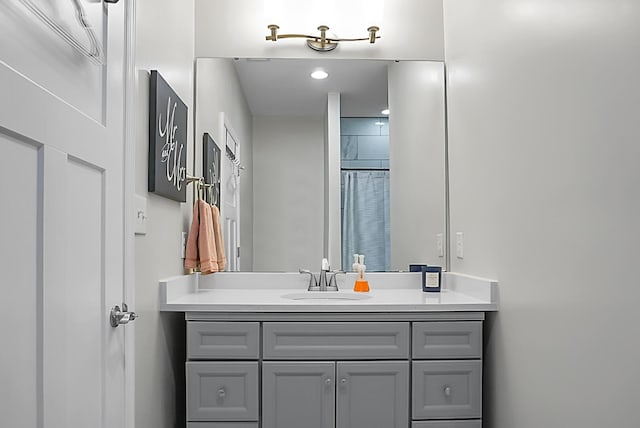 bathroom featuring vanity and curtained shower