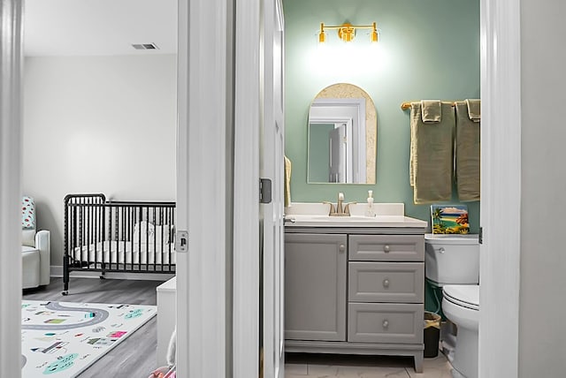 bathroom featuring vanity and toilet