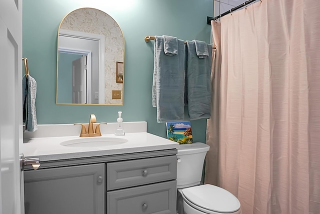 bathroom featuring vanity and toilet