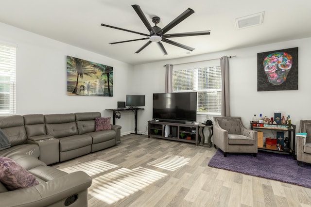 living room featuring light wood-type flooring and ceiling fan