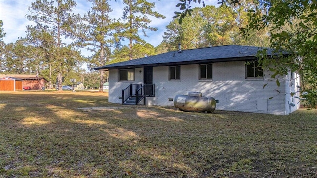 rear view of property with a lawn