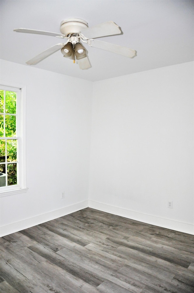 unfurnished room with ceiling fan and dark hardwood / wood-style flooring