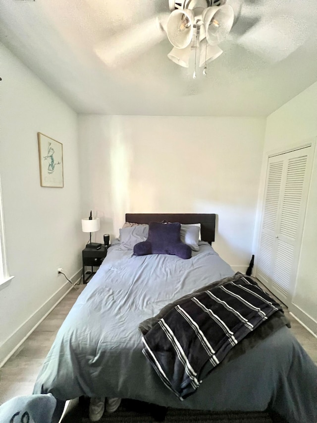 bedroom with hardwood / wood-style floors and ceiling fan