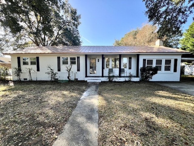 ranch-style home featuring a front yard, a porch, and a carport