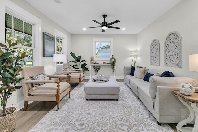 living room with light hardwood / wood-style floors and ceiling fan