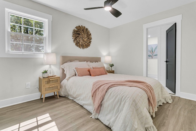 bedroom featuring connected bathroom, light hardwood / wood-style floors, and ceiling fan