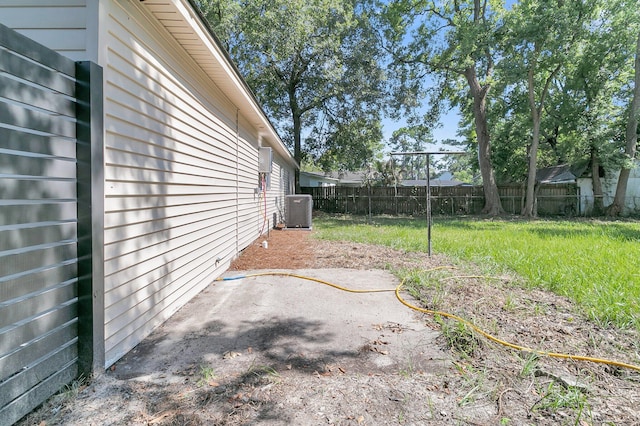 view of yard featuring central air condition unit and a patio area