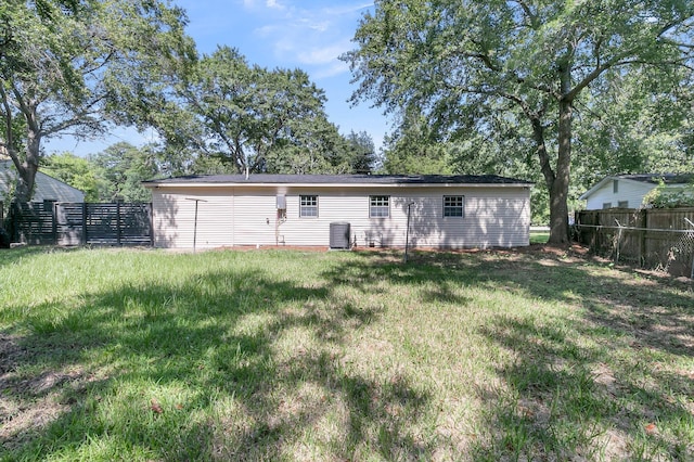 back of property with a lawn