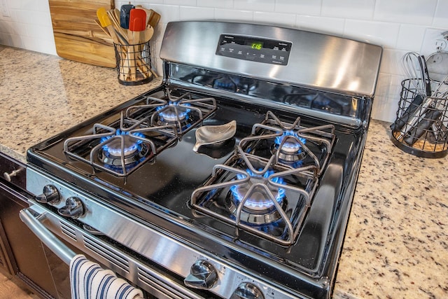 106 Sago Ct, Summerville, SC 29486 - kitchen view of stainless steel gas stove, tasteful backsplash, and light stone countertops