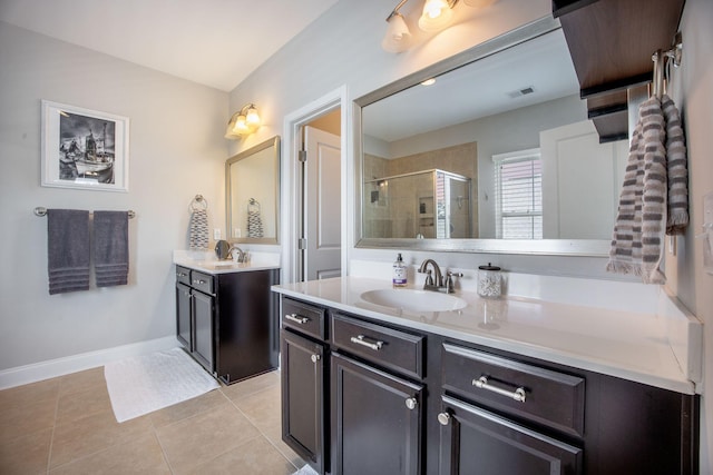106 Sago Ct, Summerville, SC 29486 - bathroom featuring two vanities, a shower stall, tile patterned floors, and baseboards