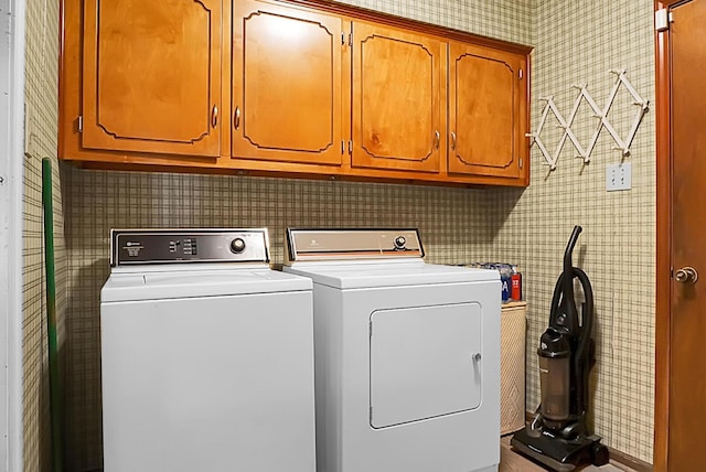 laundry room with cabinets and washer and dryer