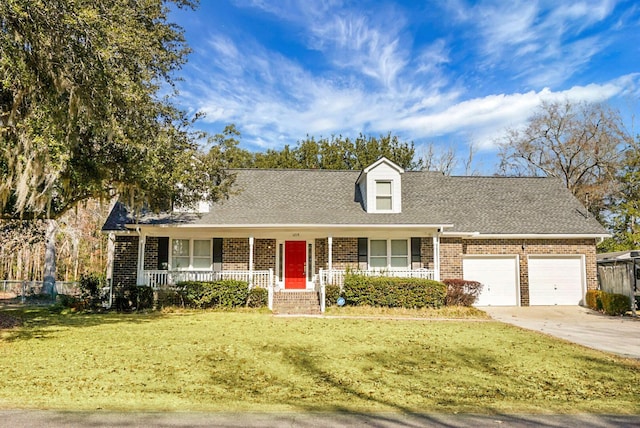 new england style home featuring a garage, a front yard, and covered porch