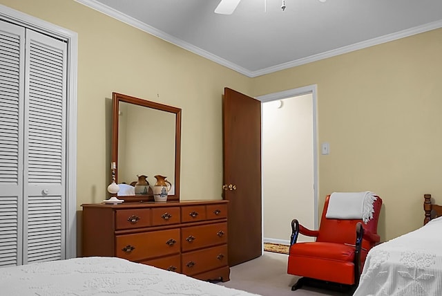 bedroom featuring ornamental molding, light colored carpet, a closet, and ceiling fan